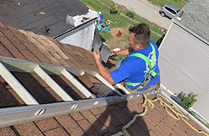 Mario Contracting replacing damaged shingles.