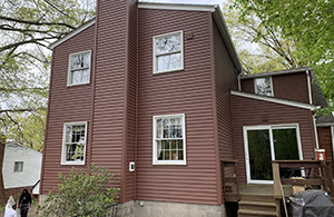 Mario Contracting installed a new roof, gutters, and siding to this house.