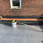 Image of rubber roof, glue, and roller
